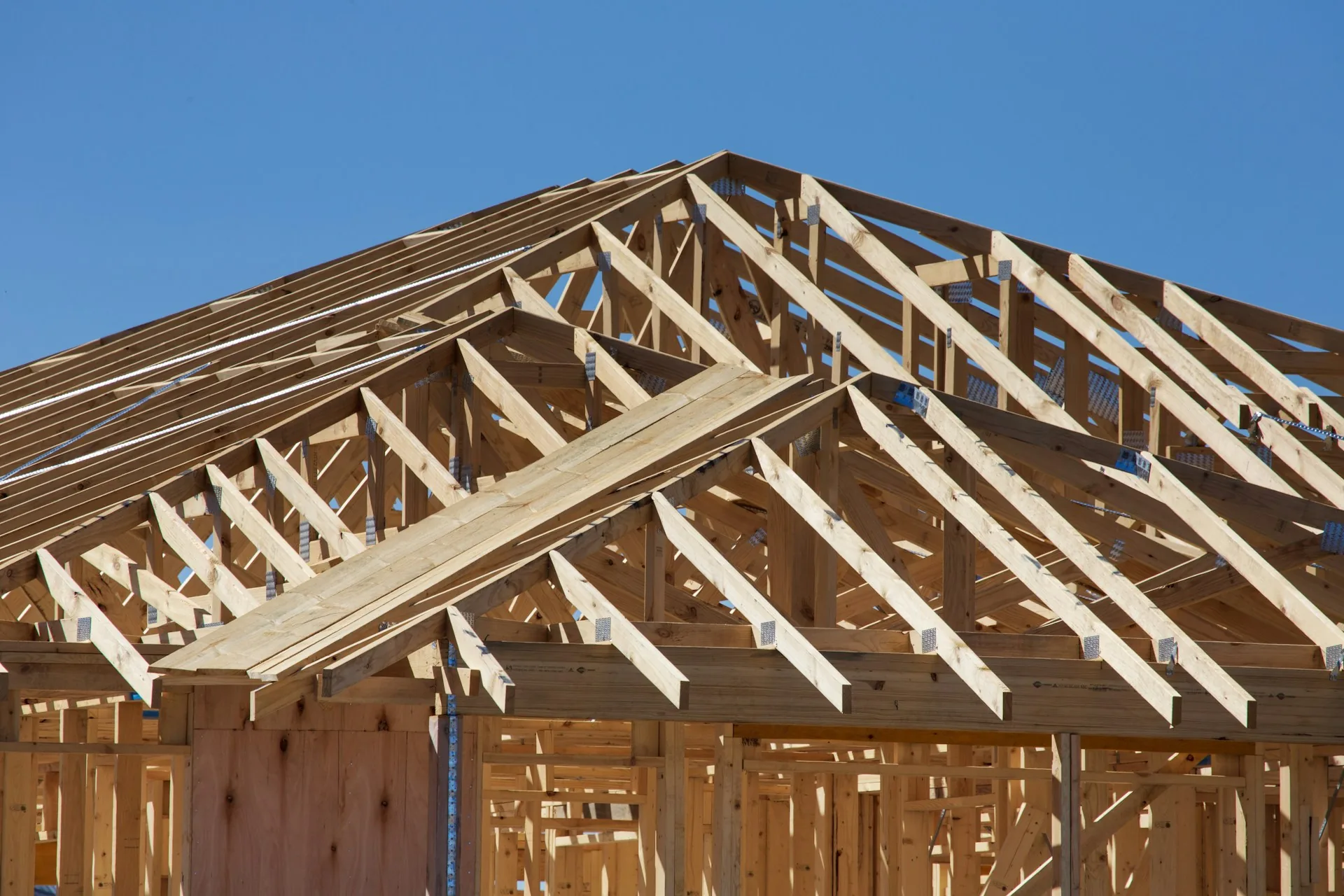House under construction with wood framing and roof trusses